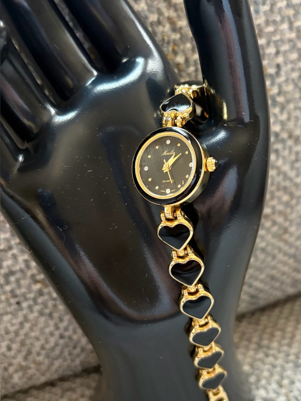 vintage Moulin quartz fashion watch. Gold tone and black enamel. 7 1/2”